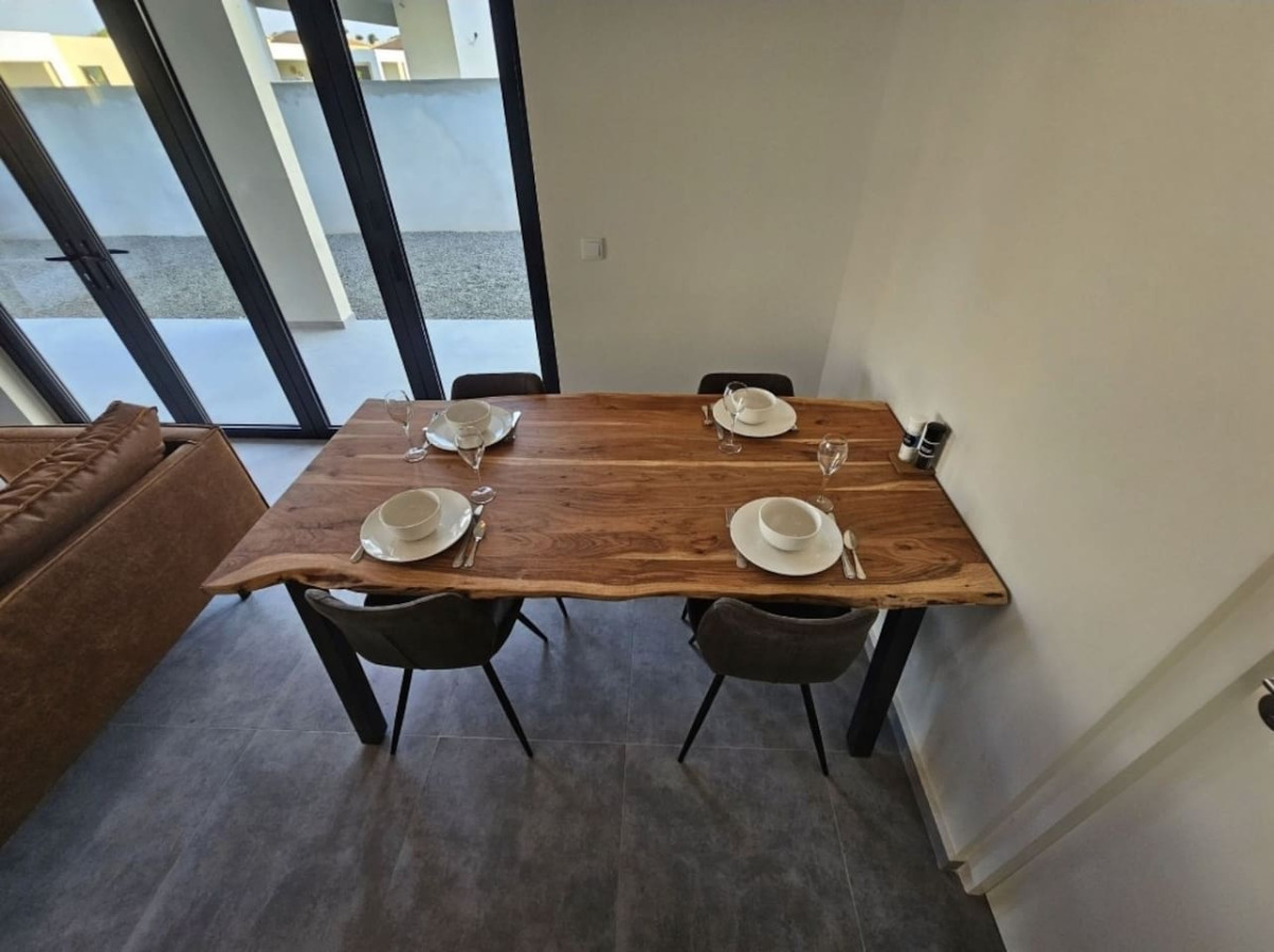 Dining area with table beside the open-plan kitchen