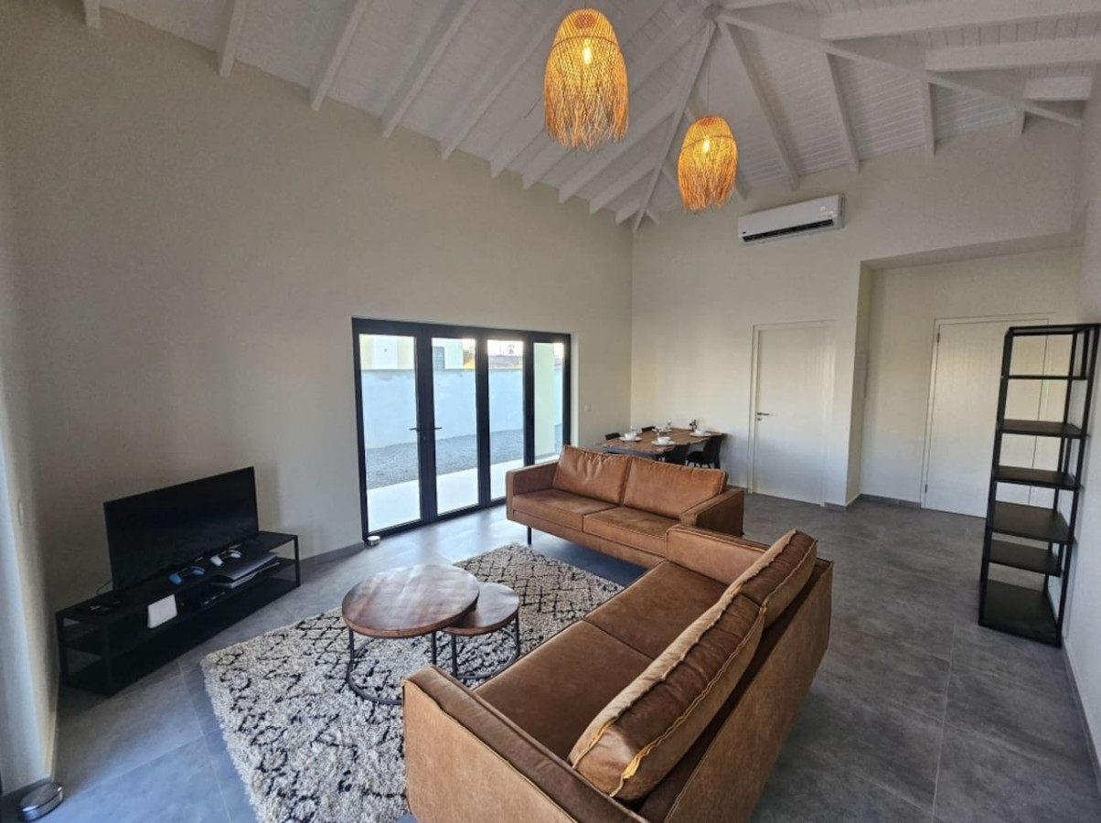 Living room with seating and direct access to the pool terrace
