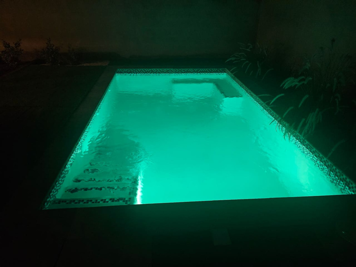 Private pool illuminated in the evening